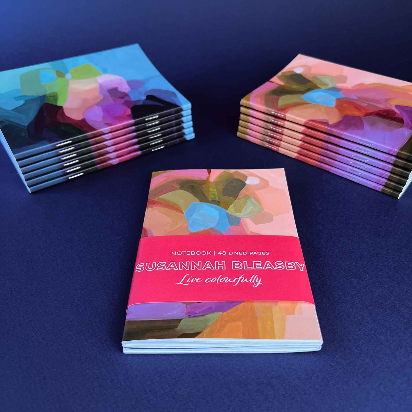 Softcover A6 notebooks with peach and blue abstract cover designs