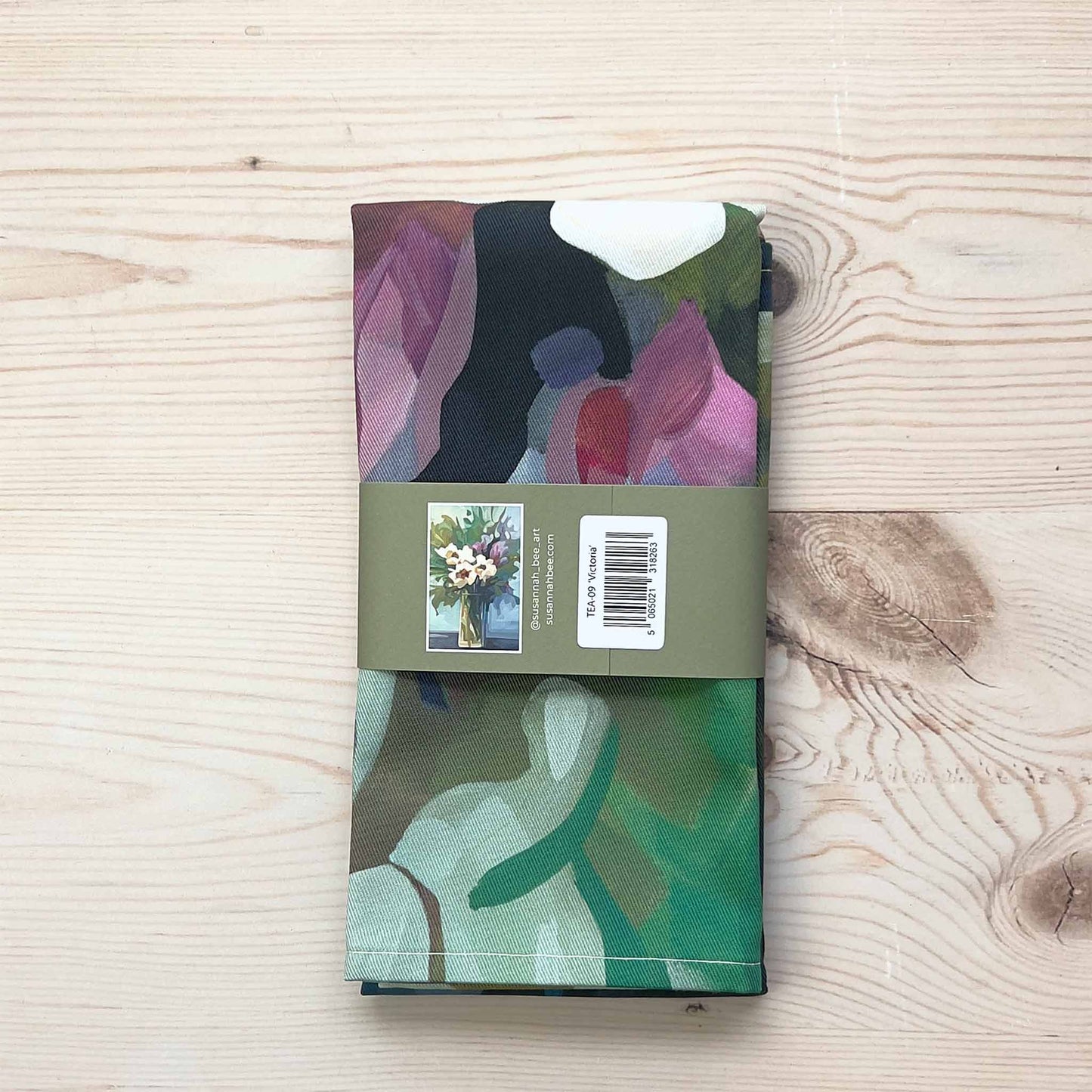 folded british floral tea towel with bellyband