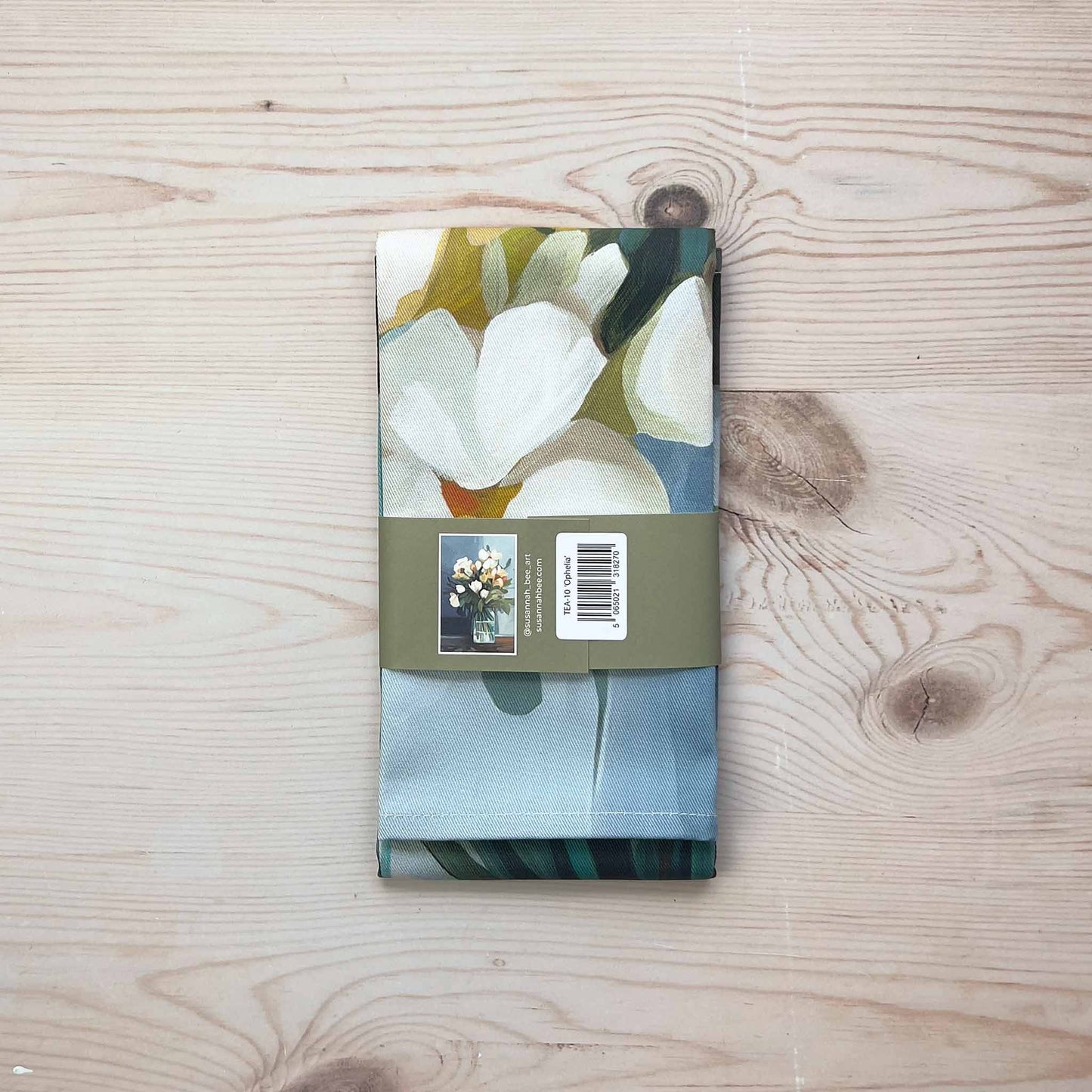 folded british tea towel packaged with a bellyband