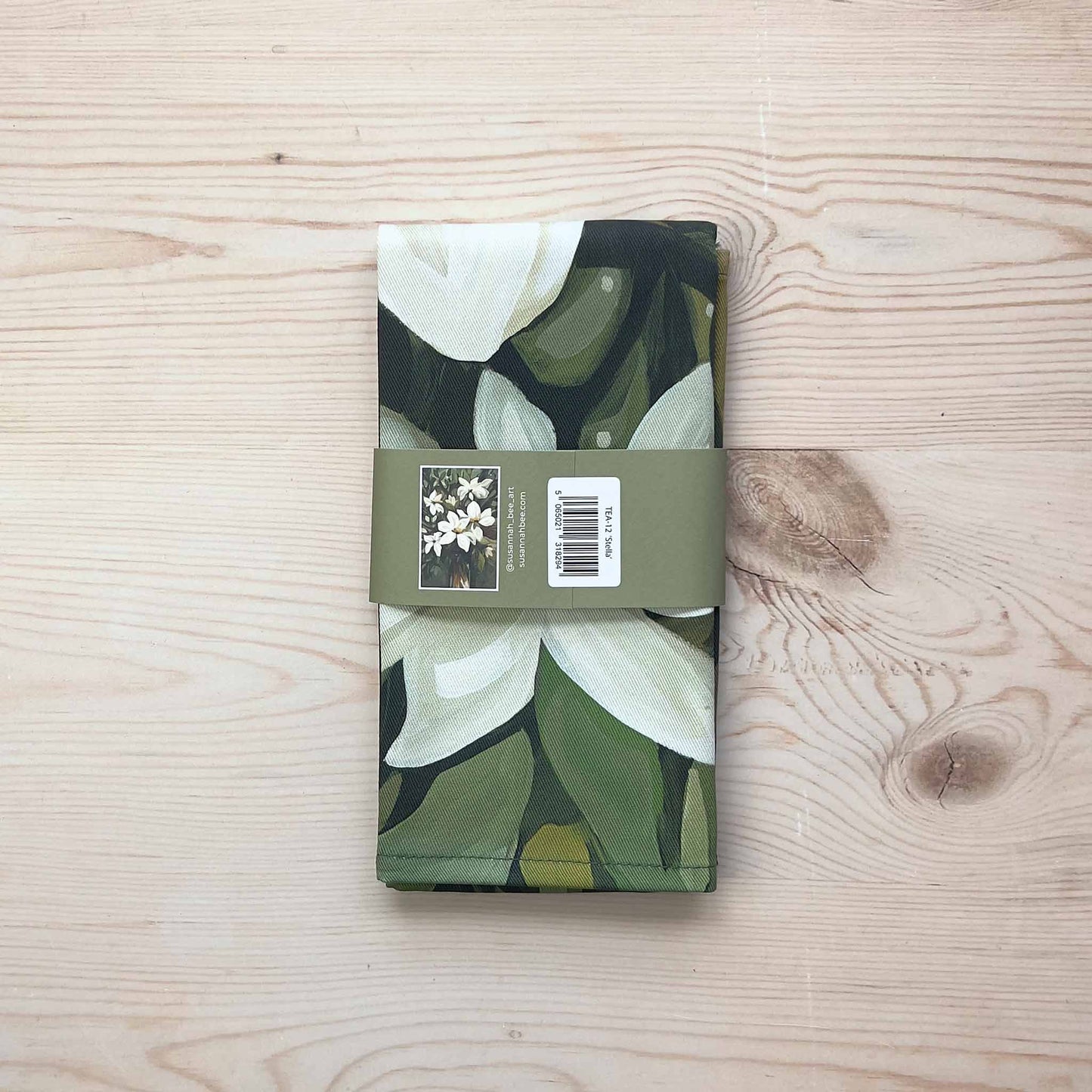 floral cotton tea towel packaged with a bellyband