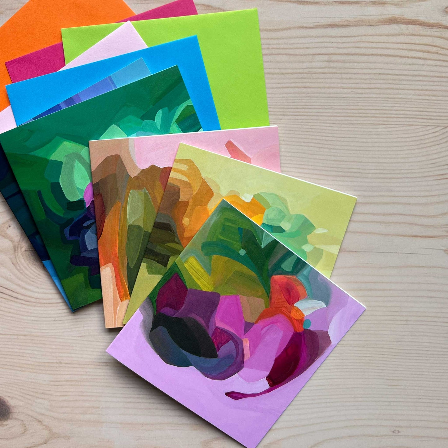 mauve abstract art card uk on a stack of colourful cards