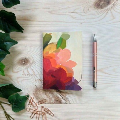 A6 softcover notebook with yellow abstract floral cover design