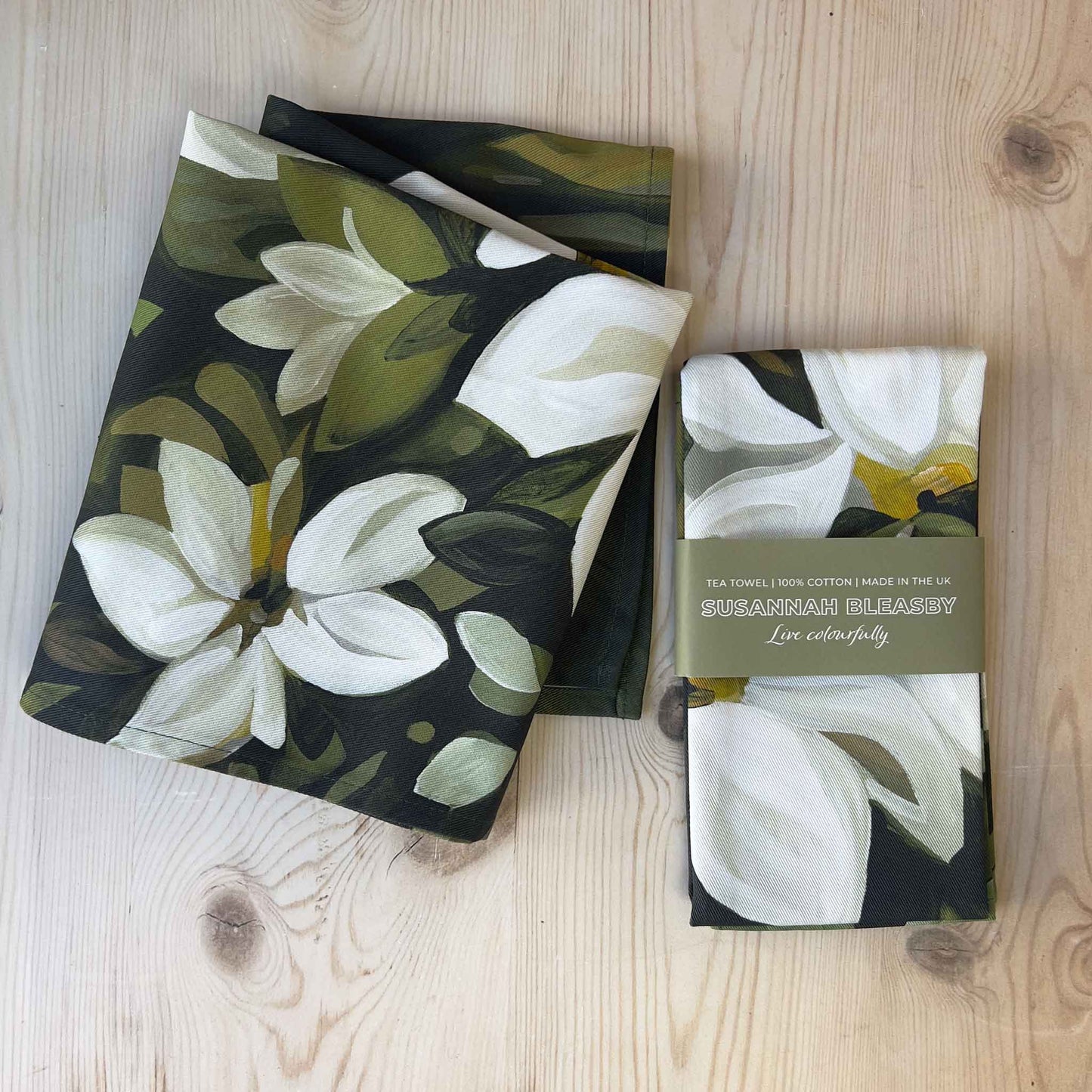 british cotton tea towels with white flowers on a forest green background