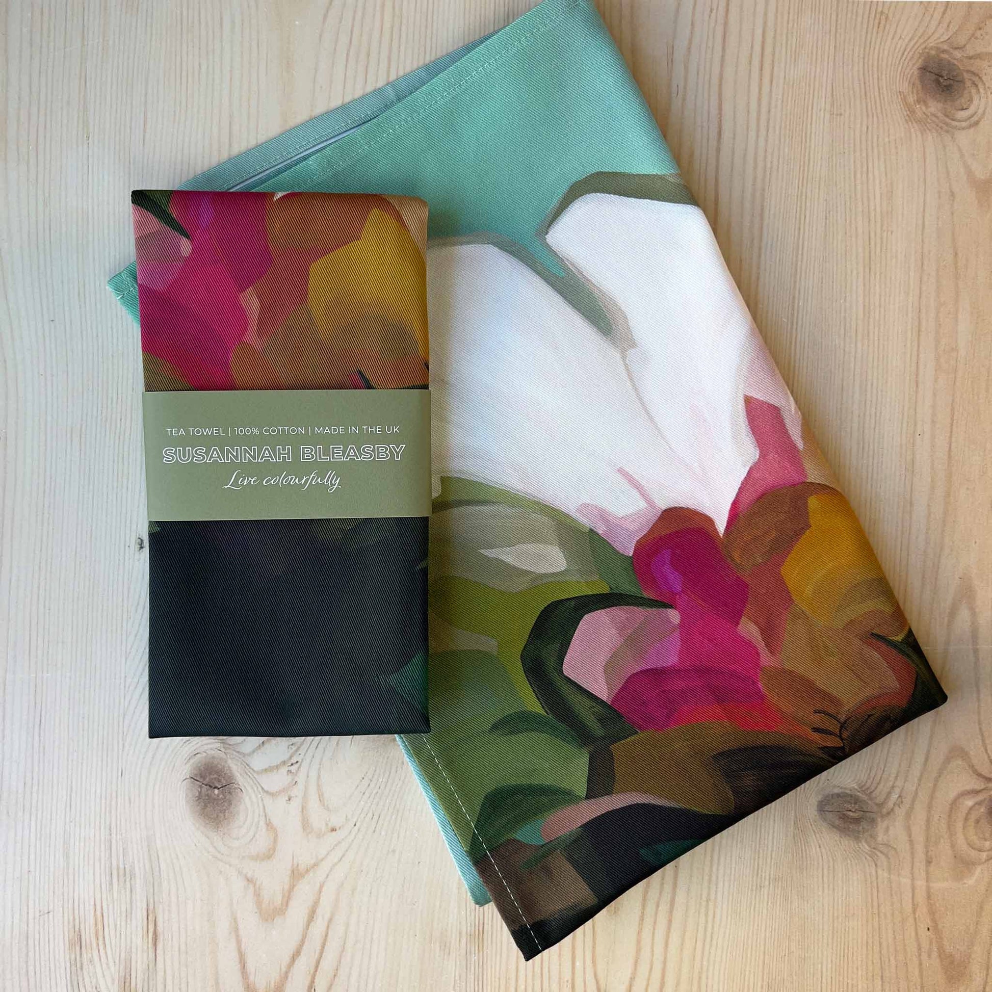 british tea towels with abstract floral design on teal background